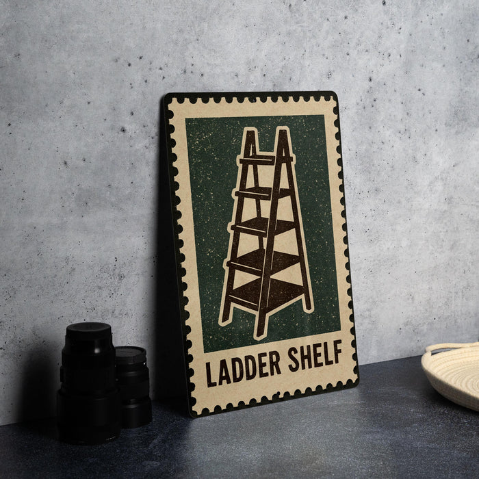 A metal sign with a ladder shelf design, placed on a countertop next to some black camera lenses.