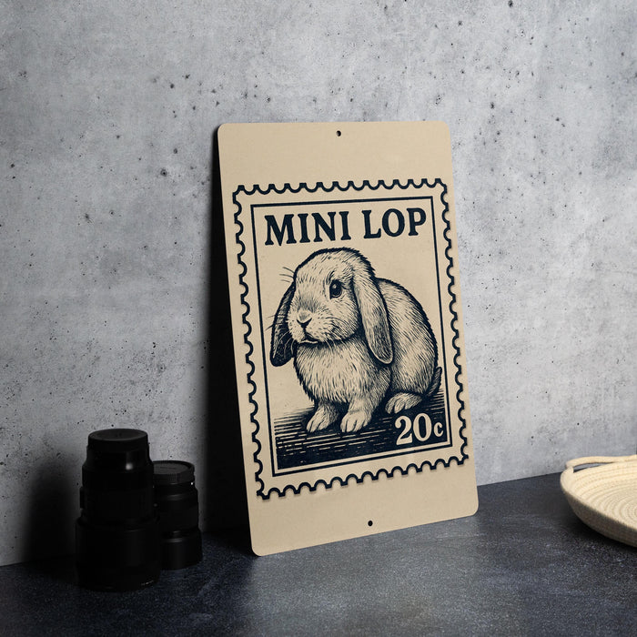 a sign with a rabbit illustration and the text "MINI LOP 20c" on it, placed on a table next to some black camera lenses.