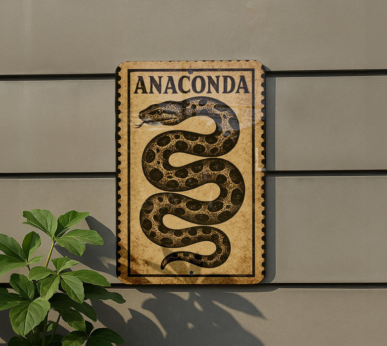 a sign with the word "Anaconda" on it, mounted on a wall next to a plant.