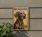 A weimaraner dog is depicted on a postage stamp-like sign, mounted on a wall.