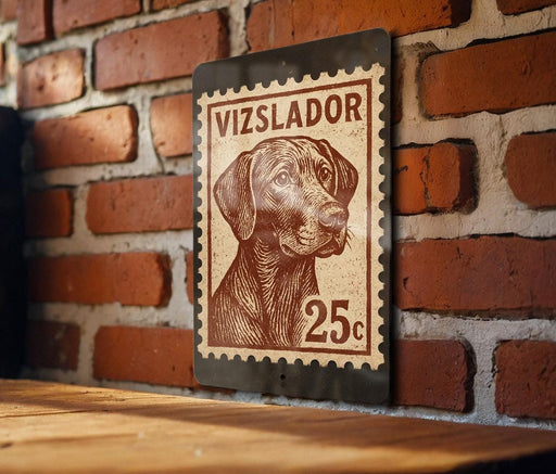 A metal sign with a dog illustration and the text "Vizslador 25c" is mounted on a brick wall.