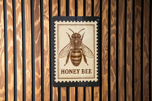 A honey bee illustration on a wooden surface, with the text "HONEY BEE" below it.