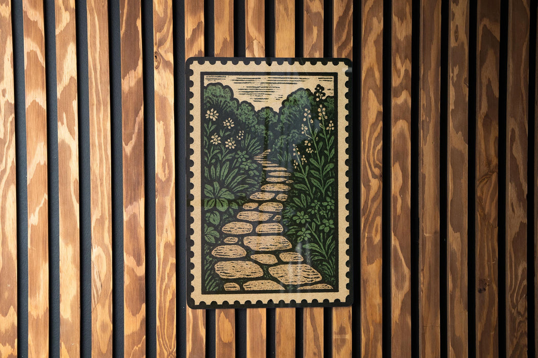 a framed illustration of a stone path winding through a lush, green landscape.