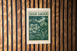 A green and white sign with the text "SHADE GARDEN" is displayed on a wooden wall.