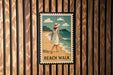 A framed poster of a woman walking on a beach, with the text "BEACH WALK" below the image.