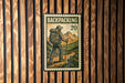 A postage stamp-like design featuring a hiker with a backpack, set against a mountain landscape.