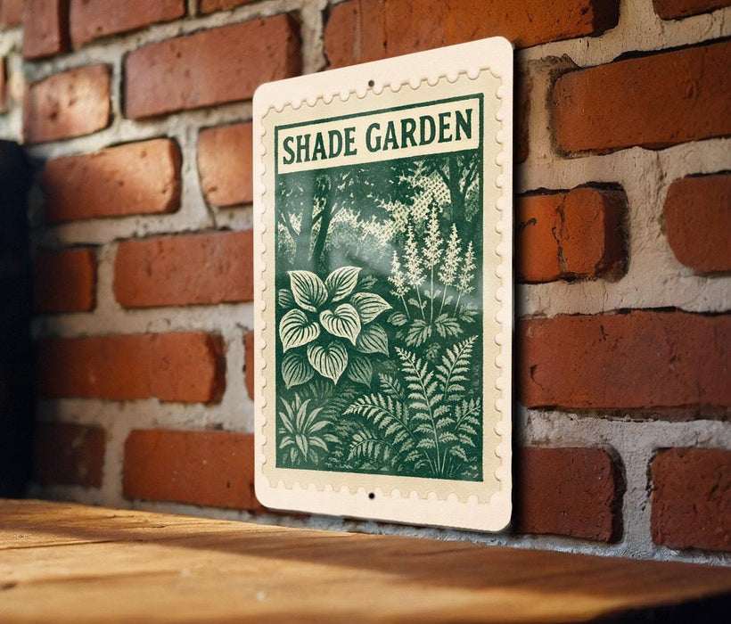 A sign for a " Shade Garden" is displayed on a brick wall, featuring a green and white illustration of plants and flowers.