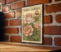 A vintage-style metal sign with a floral illustration of peonies mounted on a brick wall.