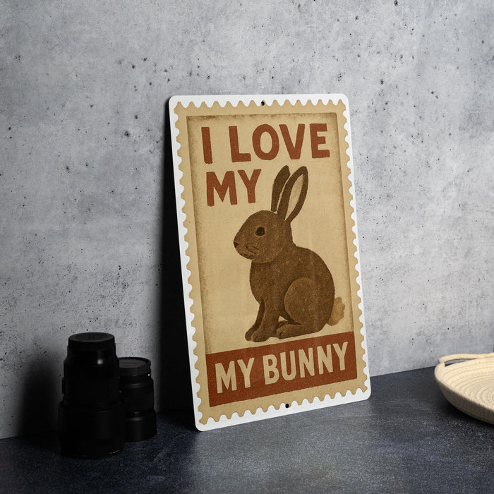 A metal sign with a cartoon rabbit and the text "I LOVE MY BUNNY" is displayed on a table.