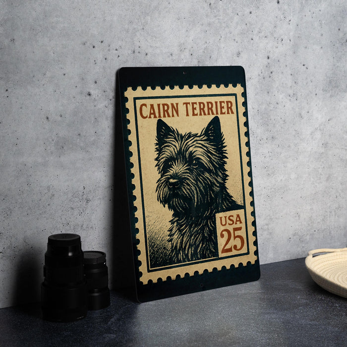 A framed image of a Cairn Terrier dog, which appears to be a postage stamp, is displayed on a table.