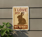 a sign with a picture of a rabbit and the text "I LOVE MY BUNNY" on a wall.