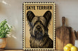 A framed poster of a Skye Terrier dog is displayed on a shelf, accompanied by a wooden cutting board, a potted plant, and some lemons.