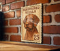 A wooden frame with a printed image of a wirehaired vizla dog, which appears to be a 25-cent stamp or postcard.