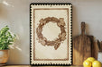 a decorative wreath with grapes and leaves on a wall, accompanied by a wooden cutting board, a potted plant, and some lemons.