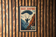 A vintage-style metal sign with a parachute illustration and the number 20, mounted on a wooden wall.