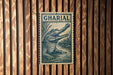 a large, detailed illustration of a crocodile, which appears to be a postage stamp or a sign with the word "GHARIAL" prominently displayed.