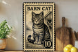 A metal sign featuring a cat illustration, with the text "BARN CAT" and the number "10" below it.