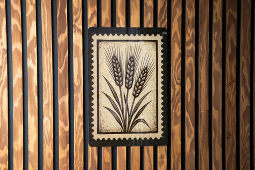 a wooden wall with a framed picture of wheat stalks.