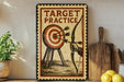 a vintage-style sign with the text "TARGET PRACTICE" and an illustration of a target with arrows. The sign is displayed on a shelf next to a wooden cutting board and a potted plant.