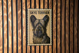 A Skye Terrier dog poster is displayed on a wooden wall.