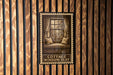A sign with the text "COTTAGE WINDOW SEAT" is displayed on a wooden wall, featuring an illustration of a window with curtains.