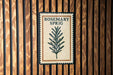 A sign for "ROSEMARY SPRIG" is displayed on a wooden wall.