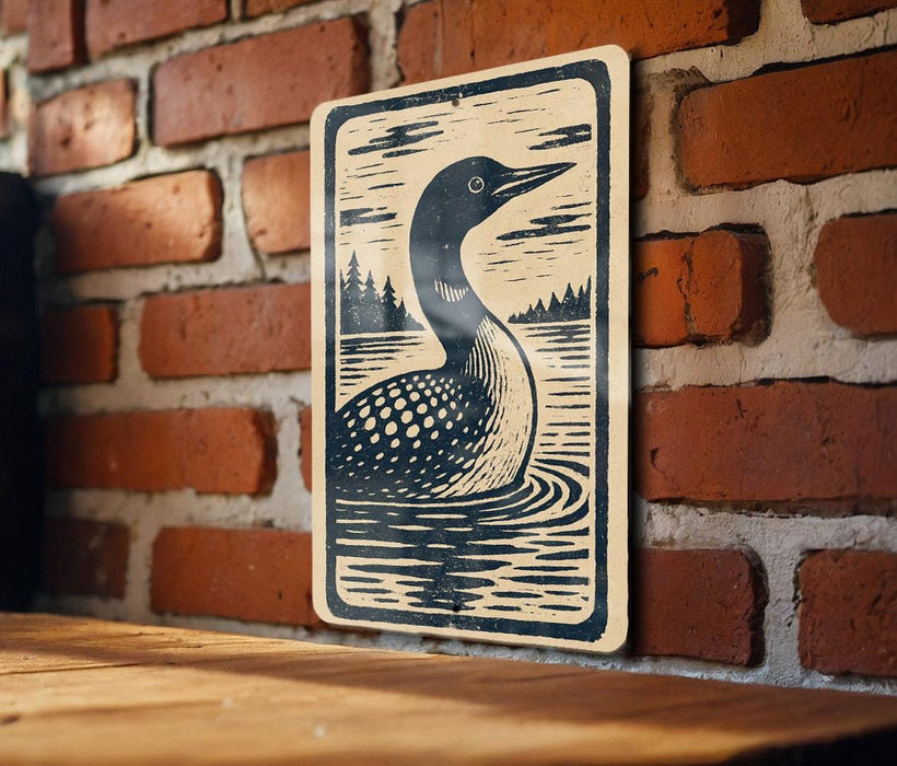 A wooden table with a decorative sign featuring a black and white illustration of a bird, likely a duck, swimming in a body of water.