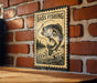 A vintage-style sign with the text "BASS FISHING" and an illustration of a fish is mounted on a brick wall.