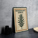 A metal sign with the text "ROSEMARY SPRIG" and a graphic of a rosemary plant is displayed on a table.