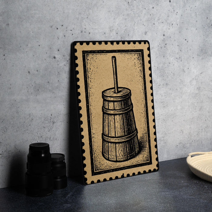 a wooden barrel with a handle, placed on a surface next to some black containers.