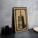 a wooden barrel with a handle, placed on a surface next to some black containers.