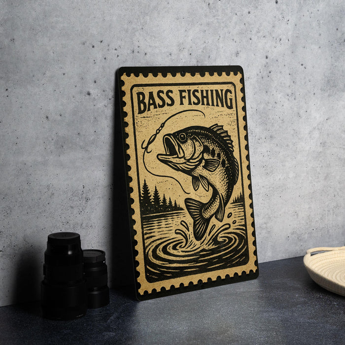 A metal sign with a fish illustration and the text "BASS FISHING" is displayed on a table.
