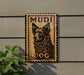 a wooden sign with a dog illustration and the word "MUDI DOG" written on it.
