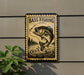A sign with a fish illustration and the text "BASS FISHING" is displayed on a wall, with a plant visible to the left.