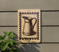 a wooden sign with a black and white illustration of a pitcher mounted on a wall.