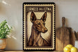a framed print of a dog, specifically a Ciroco dell' espresso dog, on a shelf.