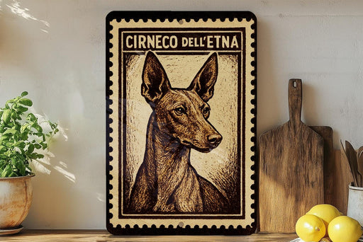 a framed print of a dog, specifically a Ciroco dell' espresso dog, on a shelf.