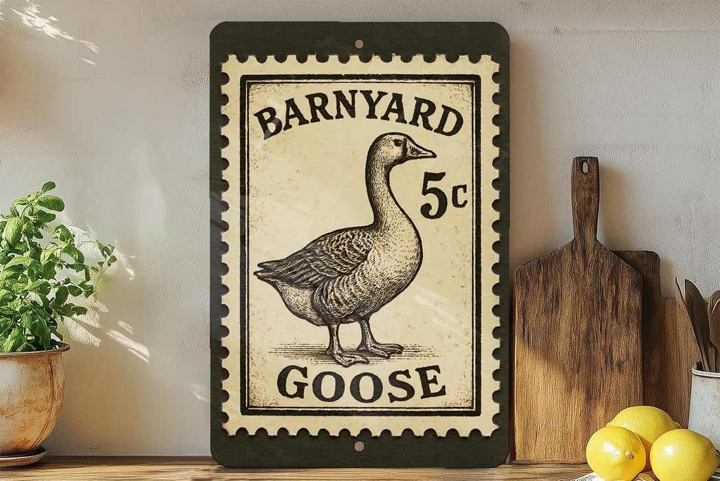 A black and white postage stamp featuring a goose, with the text "BARNYARD 5c GOOSE" printed on it. The stamp is placed on a shelf next to a wooden cutting board and some kitchen utensils.