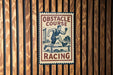a sign that reads "OBSTACLE COURSE RACING" with an illustration of a man running.