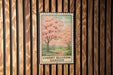 A framed image of cherry blossoms is displayed on a wooden wall, with the text "CHERRY BLOSSOM GARDEN" below the image.
