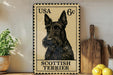 A framed image of a Scottish Terrier dog, a breed of small to medium-sized dog, is displayed on a wall next to a wooden cutting board and some kitchen utensils.