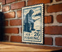A metal sign with a fishing illustration and the text "ICE FISHING 26" is displayed on a brick wall.