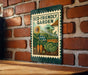 A sign for an eco-friendly garden is displayed on a brick wall, featuring illustrations of various plants and vegetables.