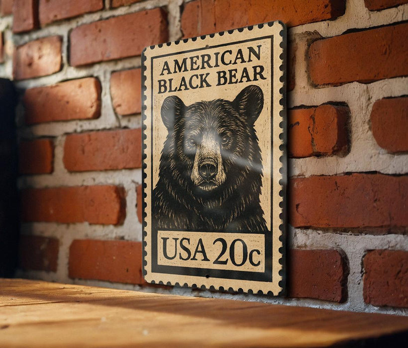 A wooden frame with a black and white illustration of a black bear on a brick wall.