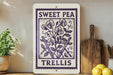 a decorative sign with a floral design, placed on a wooden surface next to a wooden cutting board and some lemons.