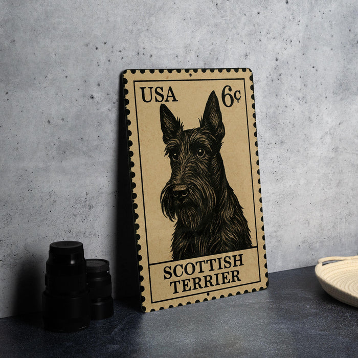 A metal stamp featuring a black and white illustration of a Scottish Terrier dog, with the text "USA 6¢" printed on it.