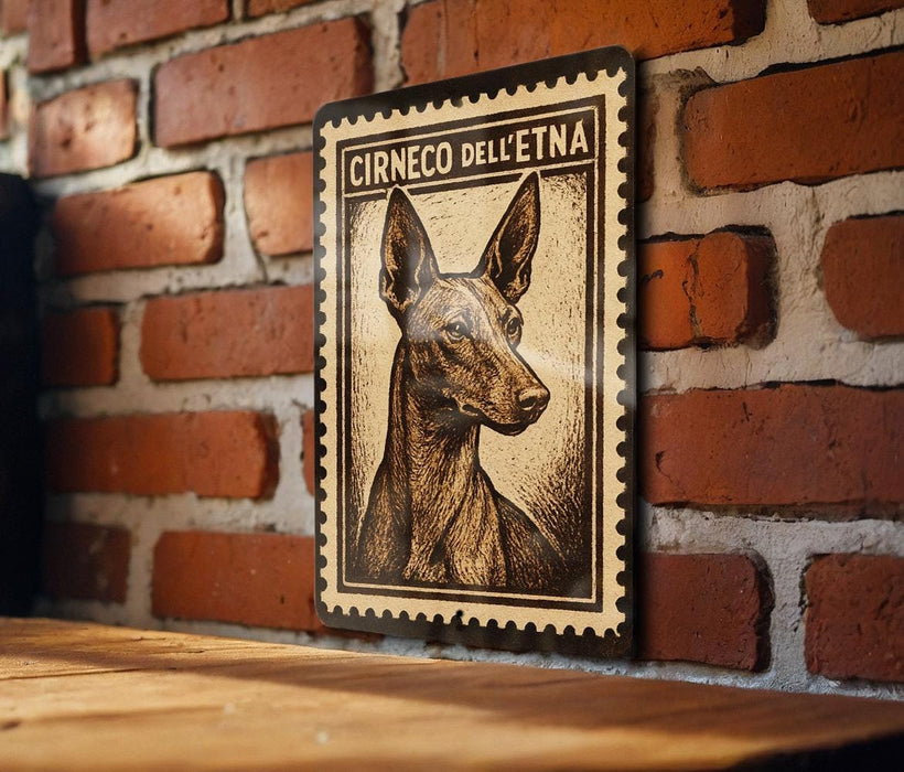 a wooden table with a framed stamp-like artwork of a dog on it, mounted on a brick wall.