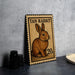 A tan rabbit stamp with the text "TAN RABBIT" and the value "20c" is displayed on a table.