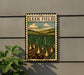 A metal sign with a colorful illustration of a field of onions hanging on a wall.