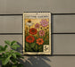 A metal sign with a postage stamp design, featuring a garden scene with flowers and plants, mounted on a wall.